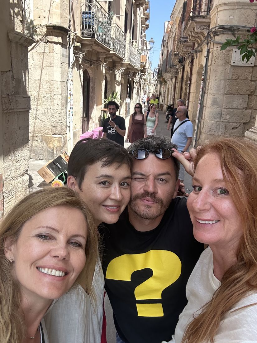 Four of the group together in a narrow street in Ortigia